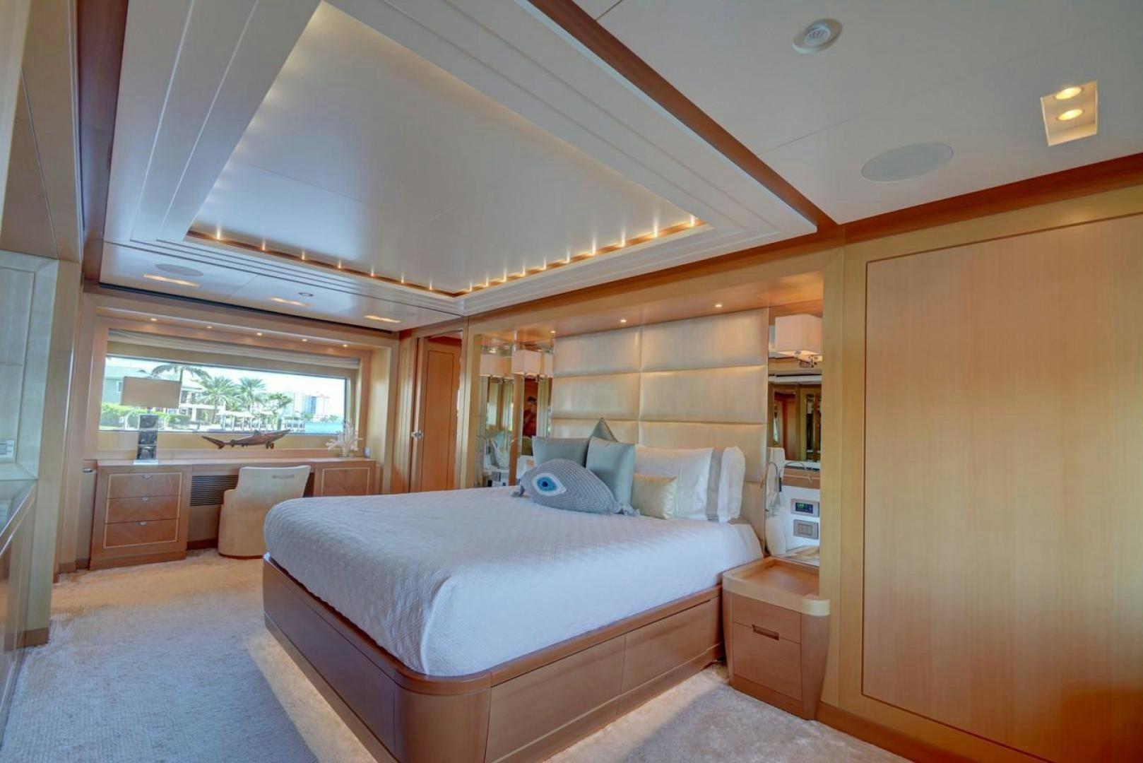 a bedroom with a bed and a window aboard KAOS Yacht for Sale