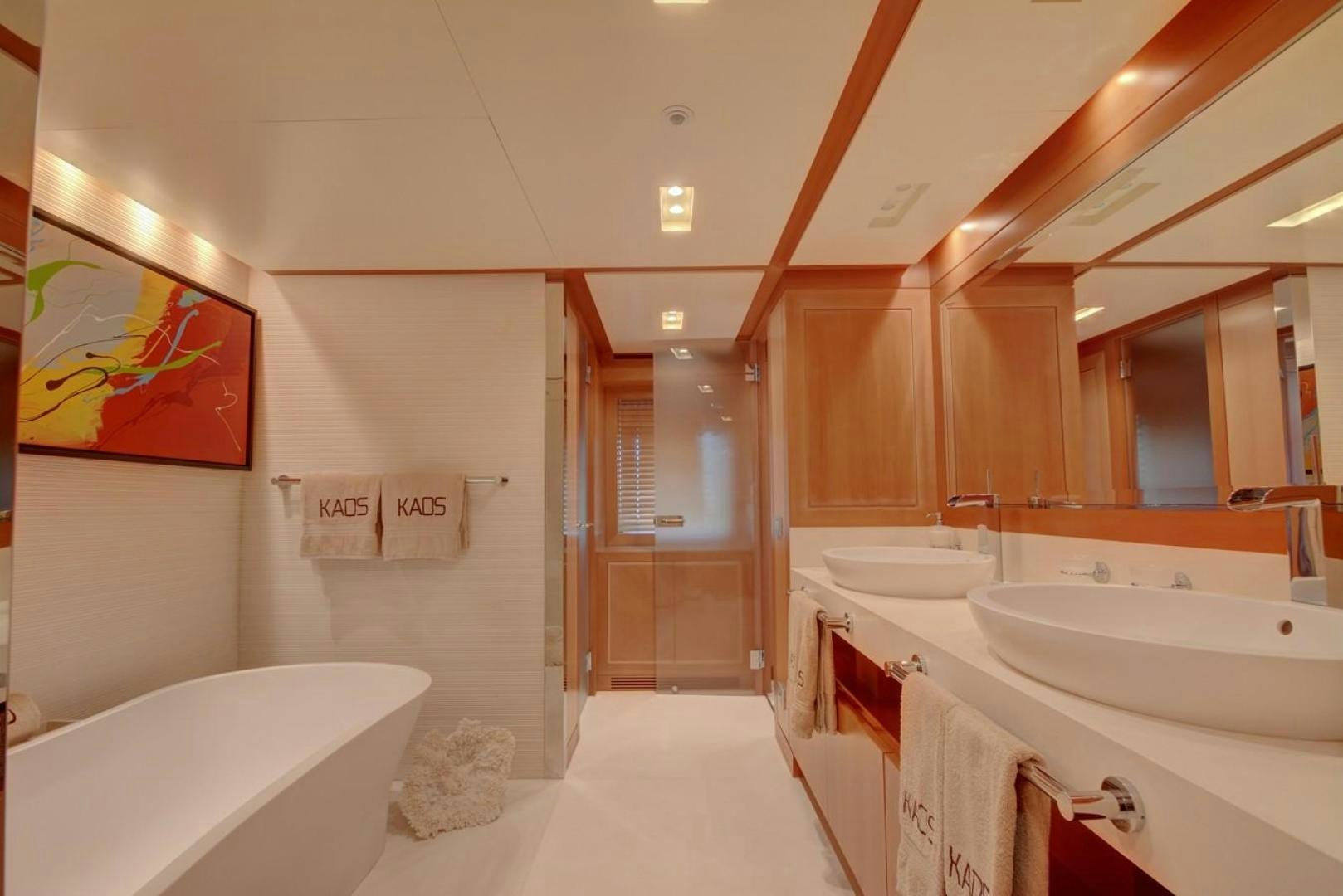 a bathroom with a bathtub and sinks aboard KAOS Yacht for Sale