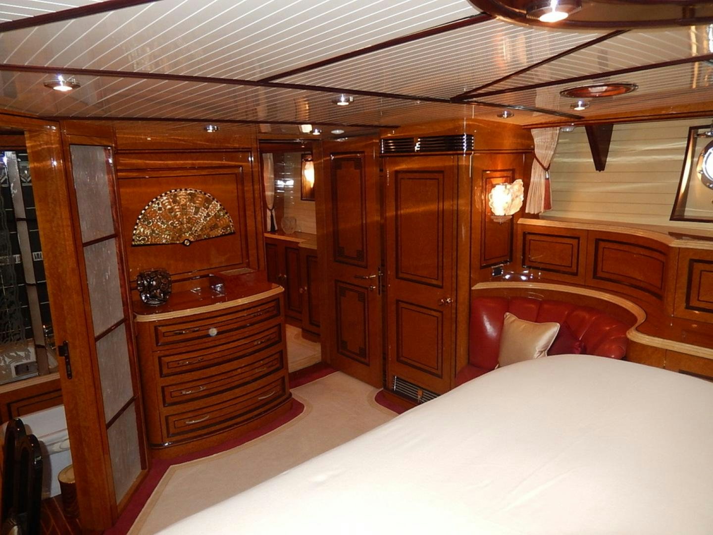 a bedroom with a bed and a dresser aboard ATLANTIDE Yacht for Sale