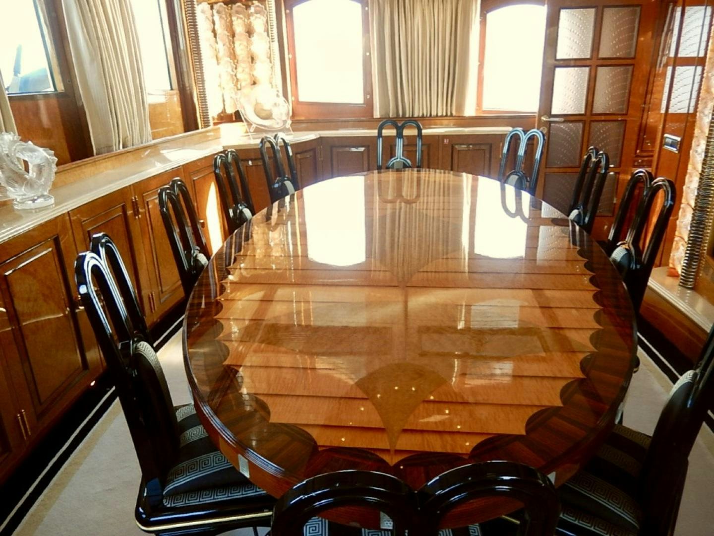 a dining table with chairs aboard ATLANTIDE Yacht for Sale
