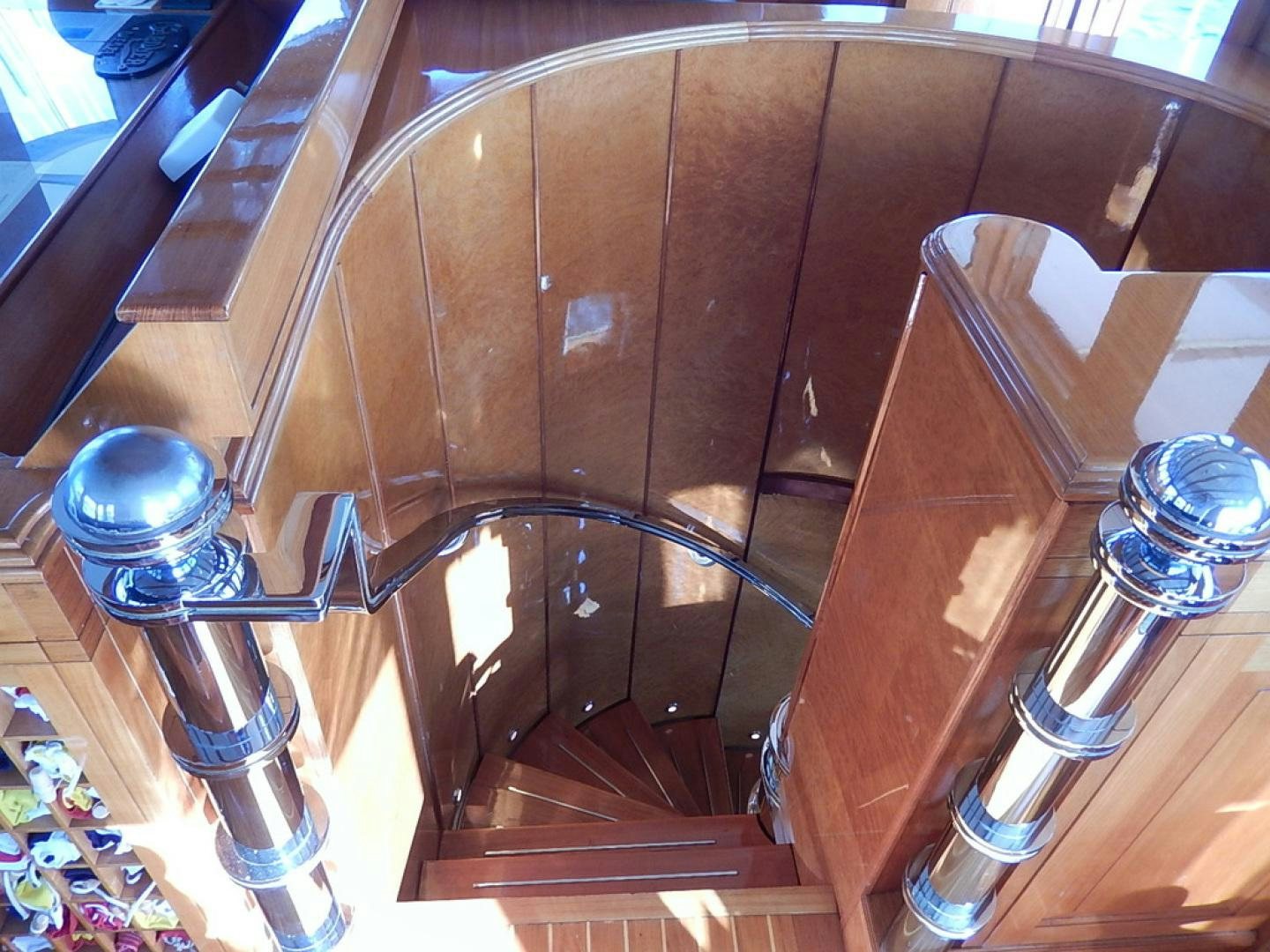 a wooden staircase with a glass railing aboard ATLANTIDE Yacht for Sale