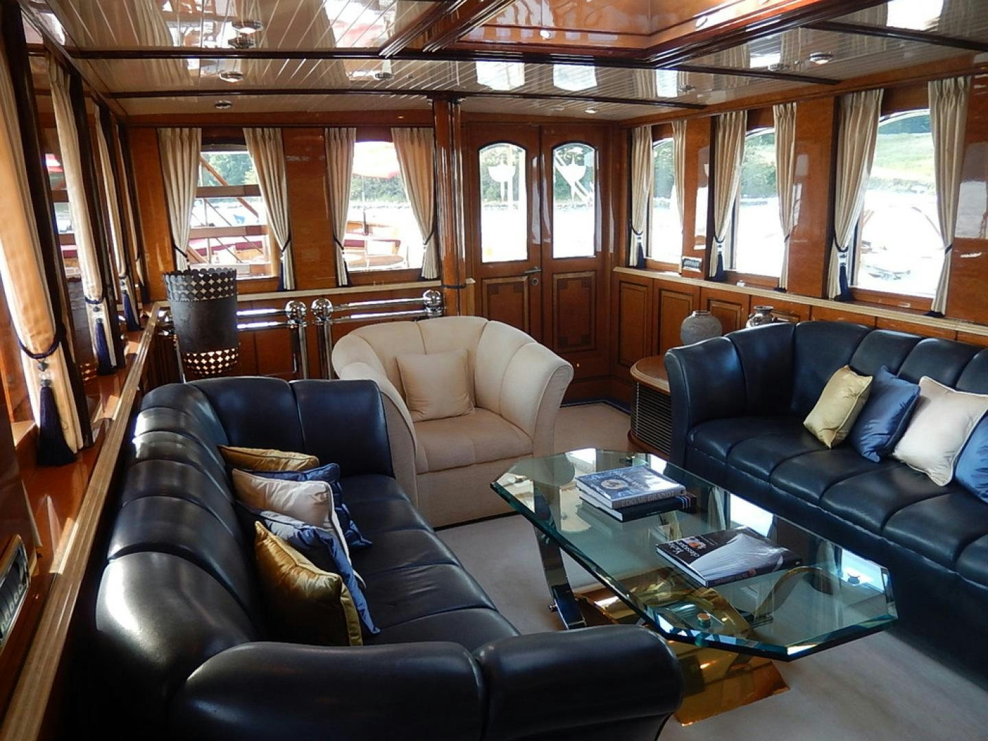 a living room with leather couches aboard ATLANTIDE Yacht for Sale
