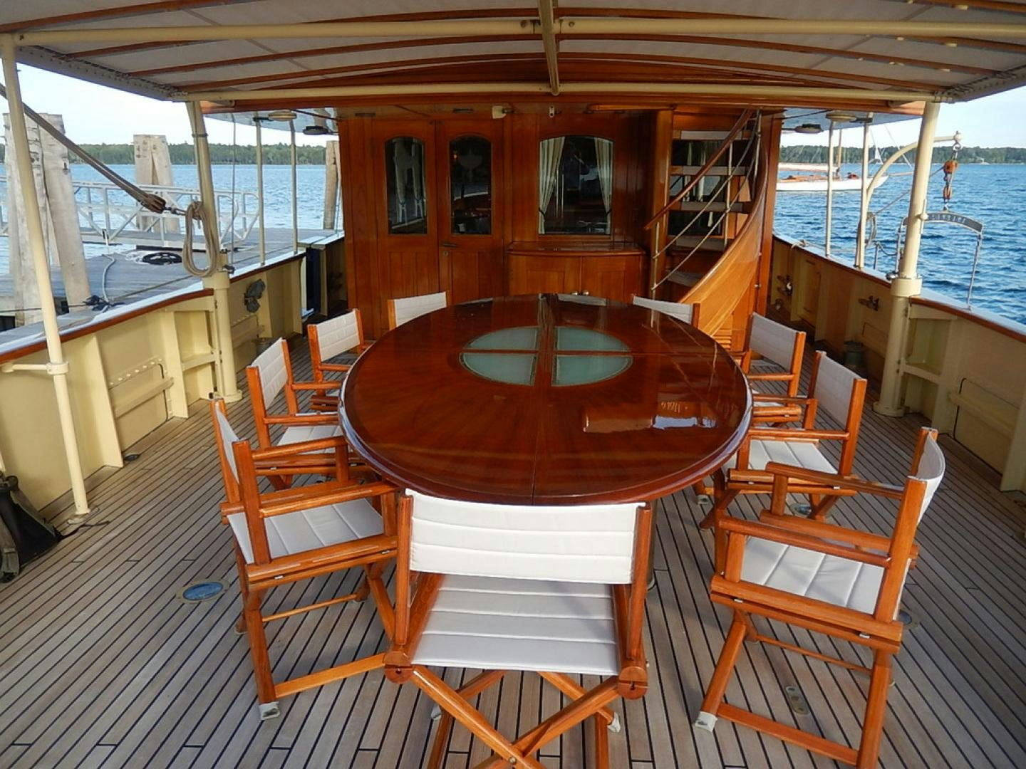 a boat with a table and chairs aboard ATLANTIDE Yacht for Sale