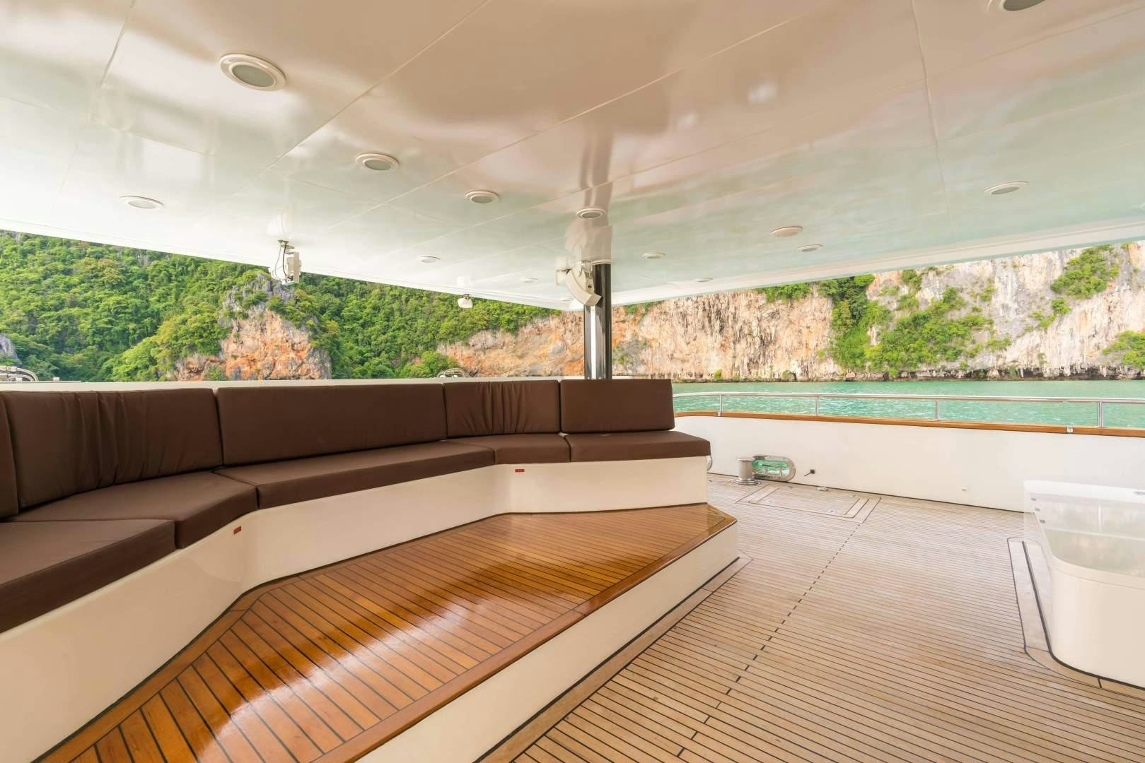 a room with a wood floor and a large window with a wood paneling and a wood floor aboard PHATSARA Yacht for Sale