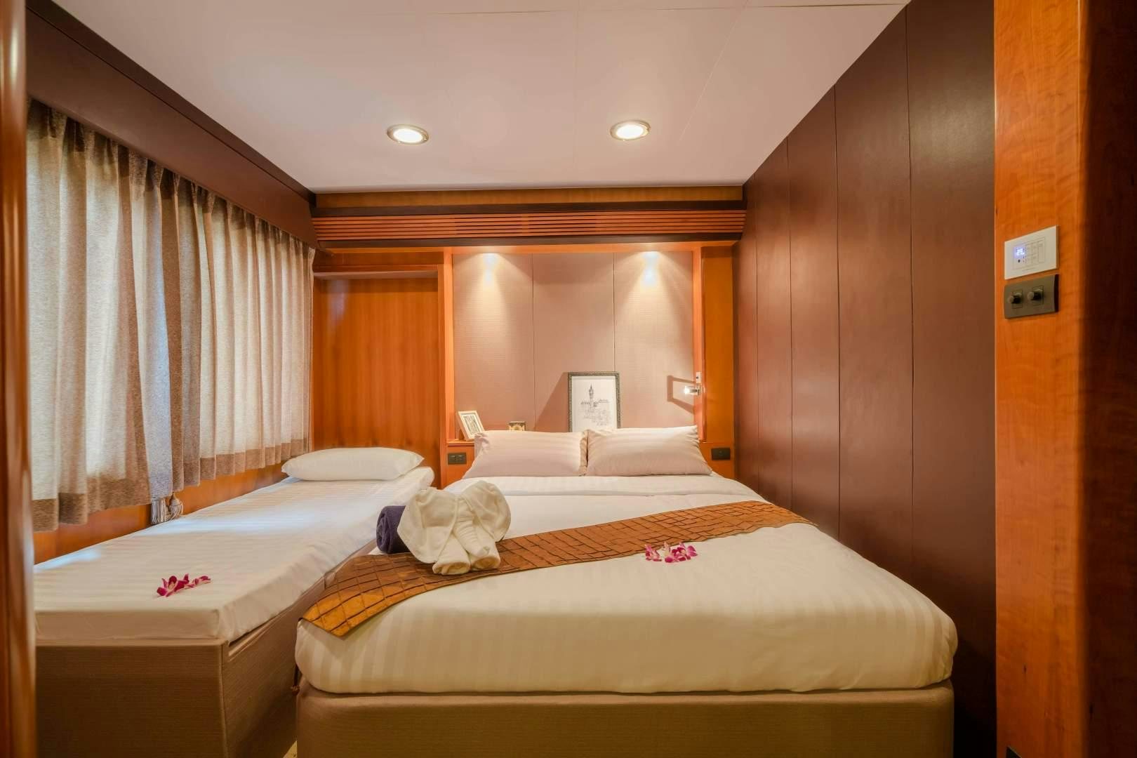 a room with two beds aboard PHATSARA Yacht for Sale