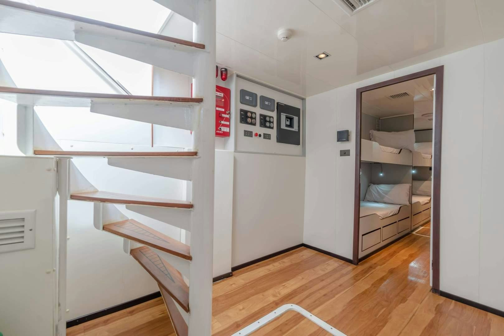 a room with a door and a shelf with electronic devices on it aboard PHATSARA Yacht for Sale