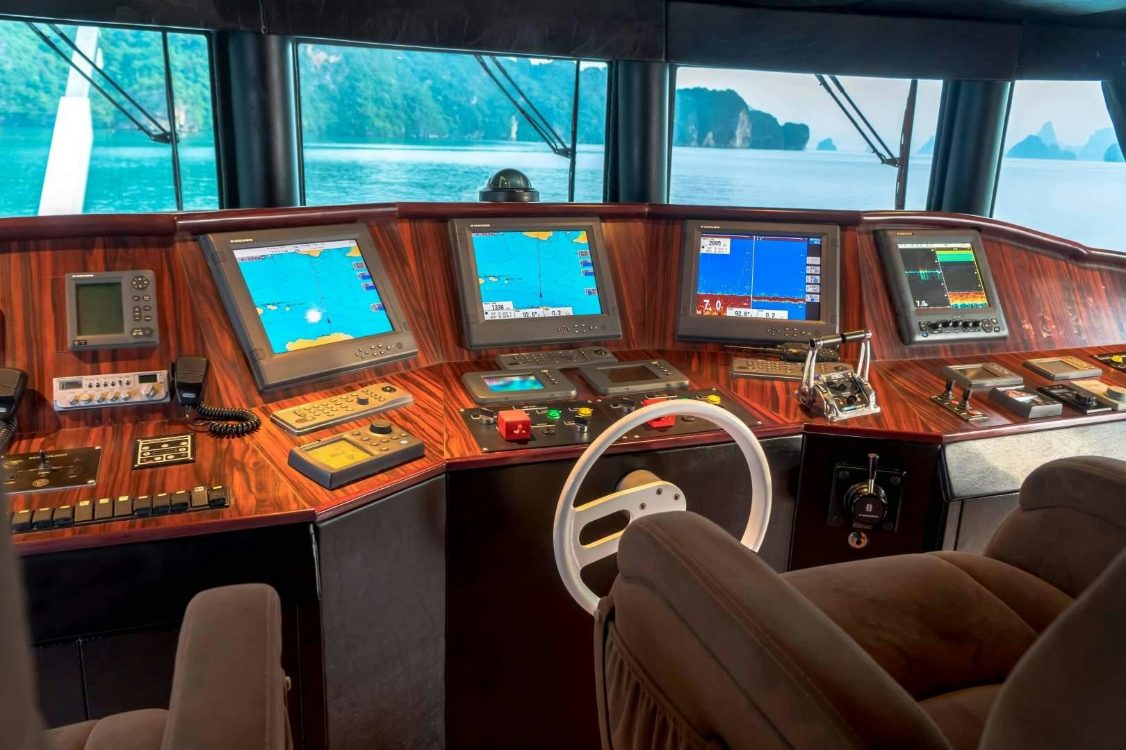 a desk with computers and monitors aboard PHATSARA Yacht for Sale