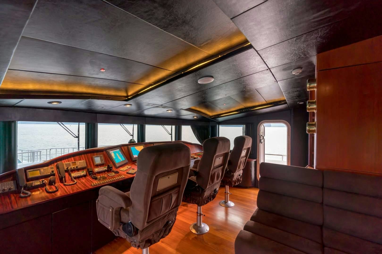 inside of a vehicle with a table and chairs and a couch aboard PHATSARA Yacht for Sale