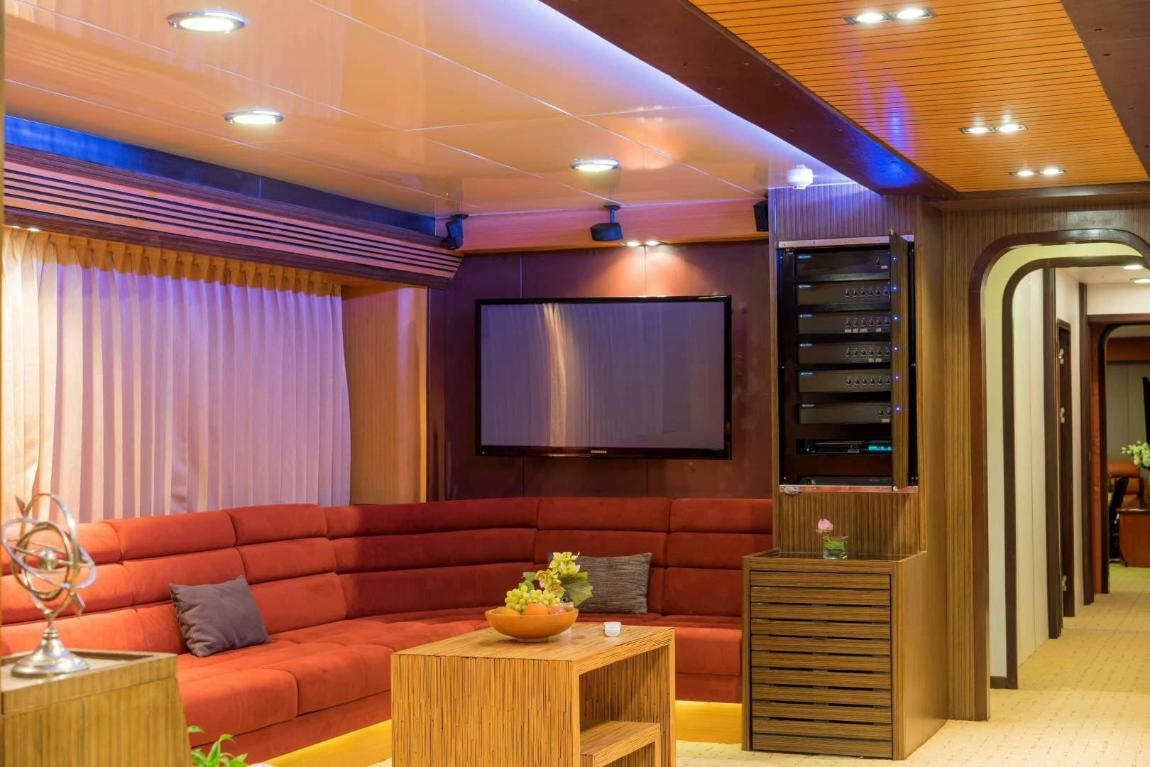 a living room with a couch and a television aboard PHATSARA Yacht for Sale