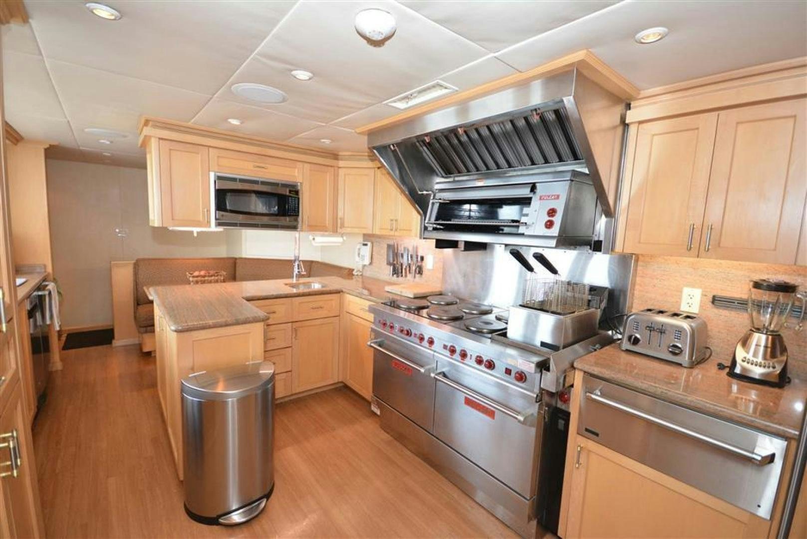 a kitchen with a stove and a refrigerator aboard AR DE Yacht for Sale