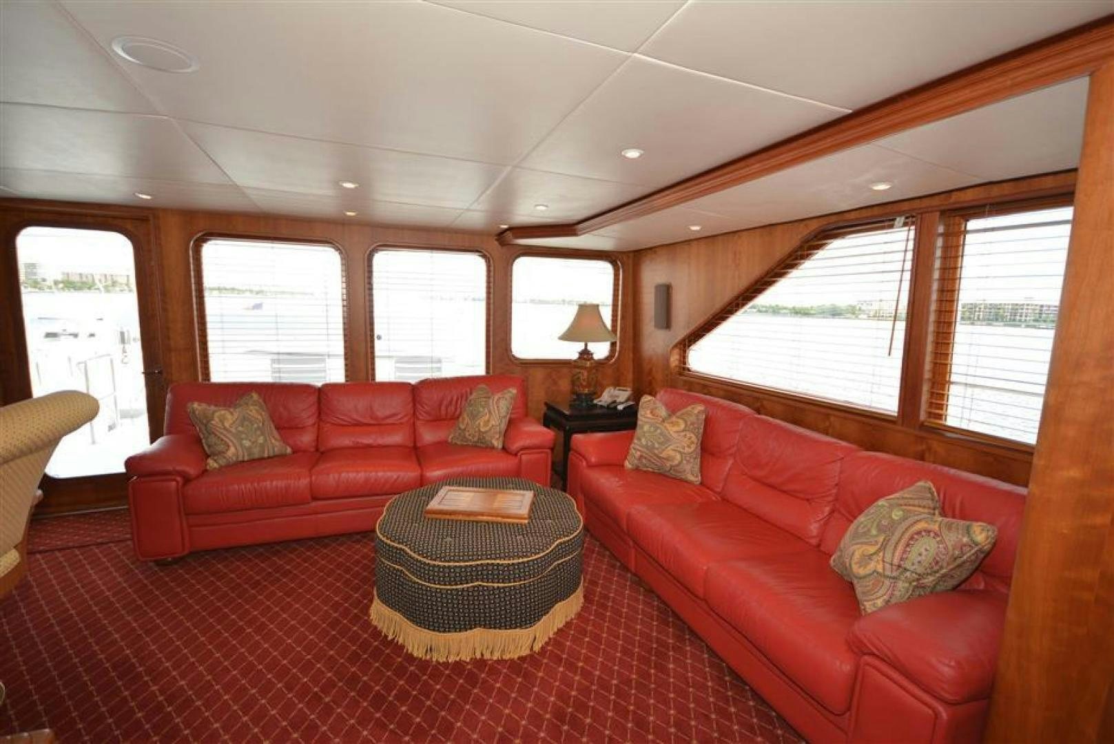 a living room with red couches aboard AR DE Yacht for Sale