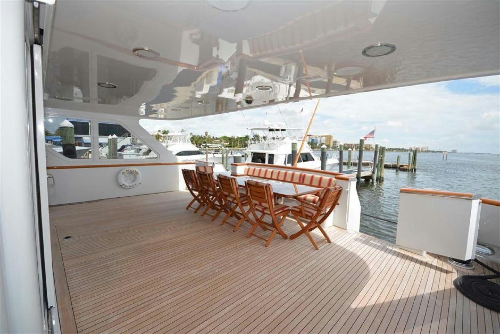 a deck with chairs and a table on it aboard AR DE Yacht for Sale
