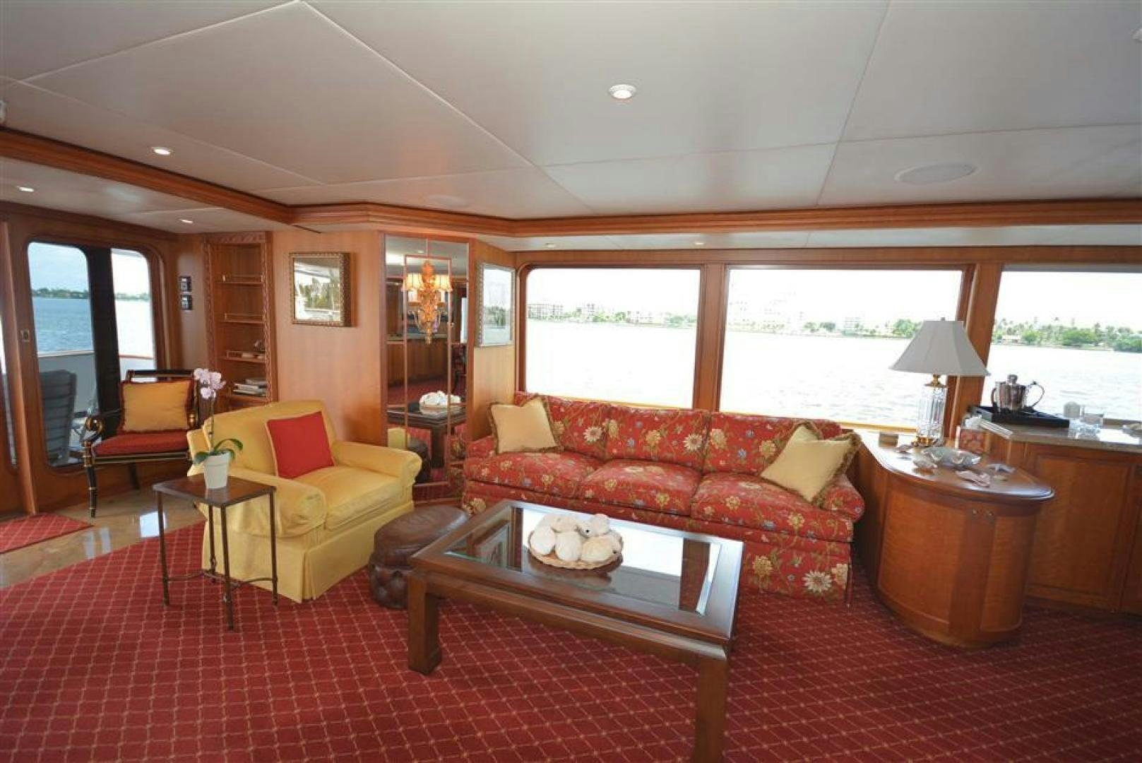 a living room with a red couch and a coffee table aboard AR DE Yacht for Sale