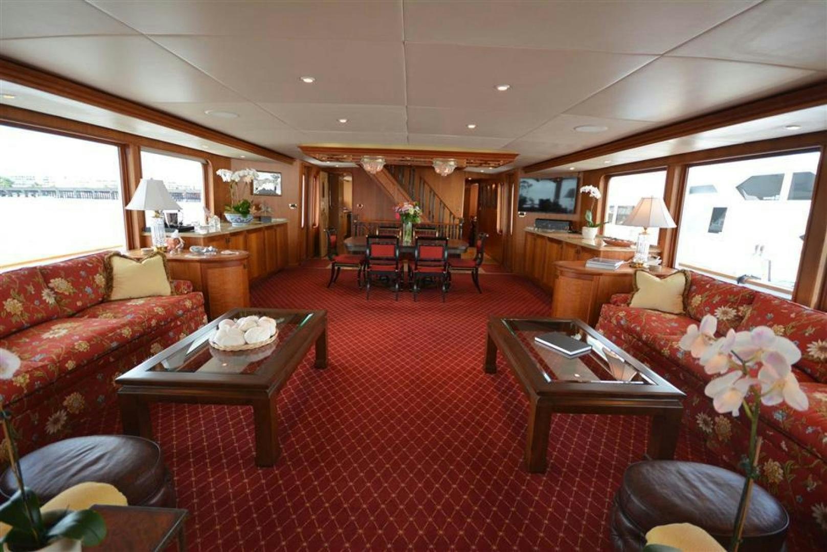 a living room with a red rug aboard AR DE Yacht for Sale
