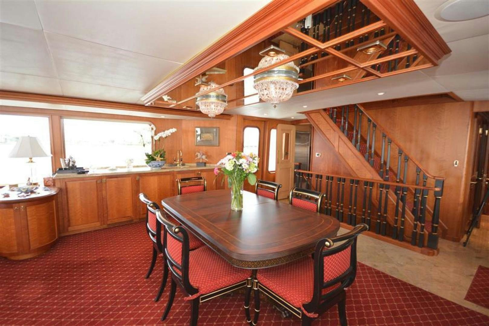 a large room with a table and chairs aboard AR DE Yacht for Sale