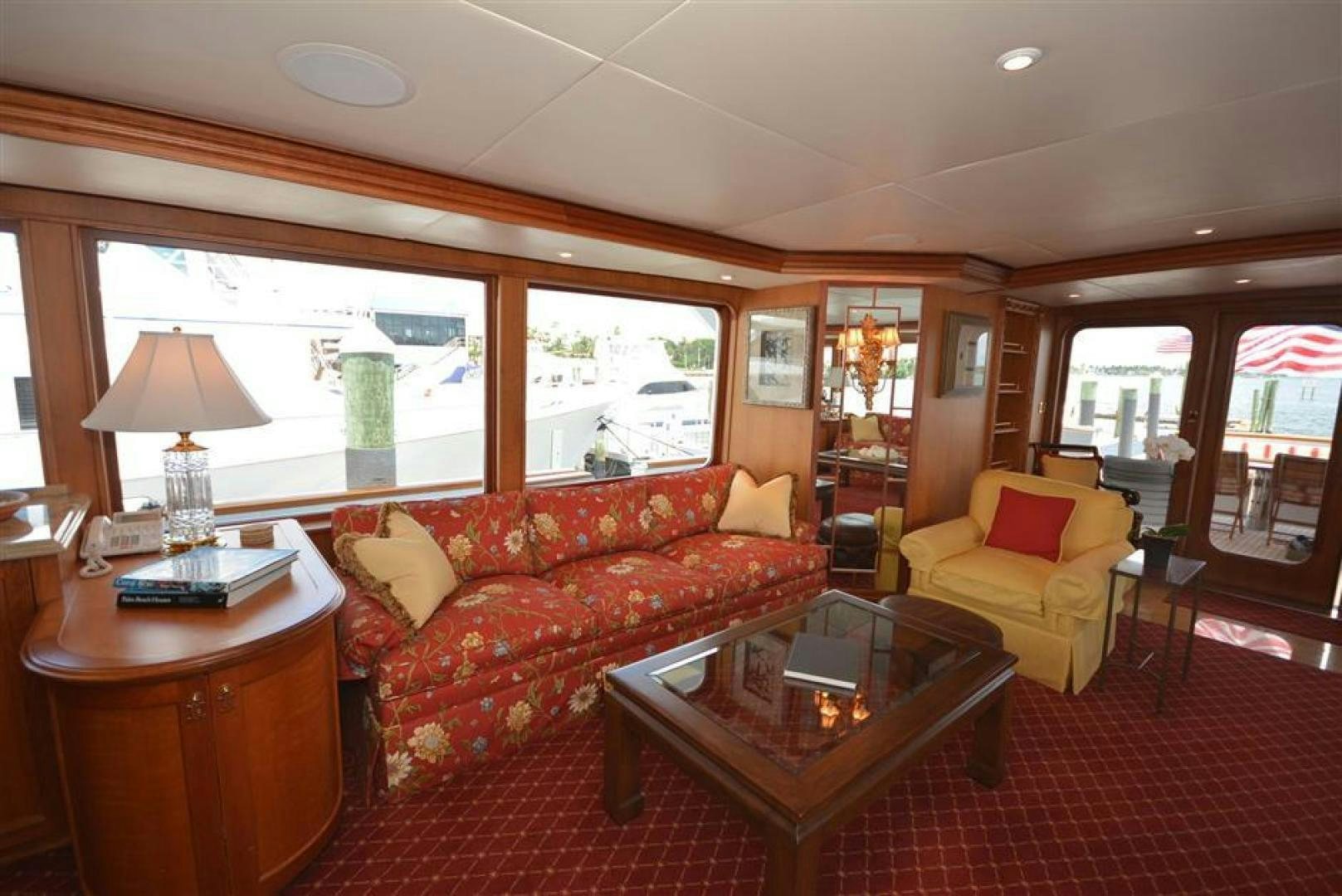 a living room with a red couch and a coffee table aboard AR DE Yacht for Sale