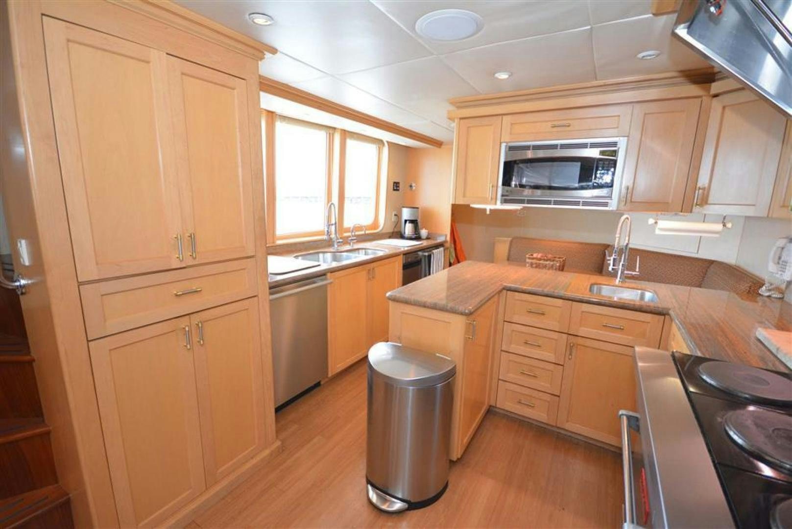 a kitchen with wooden cabinets aboard AR DE Yacht for Sale