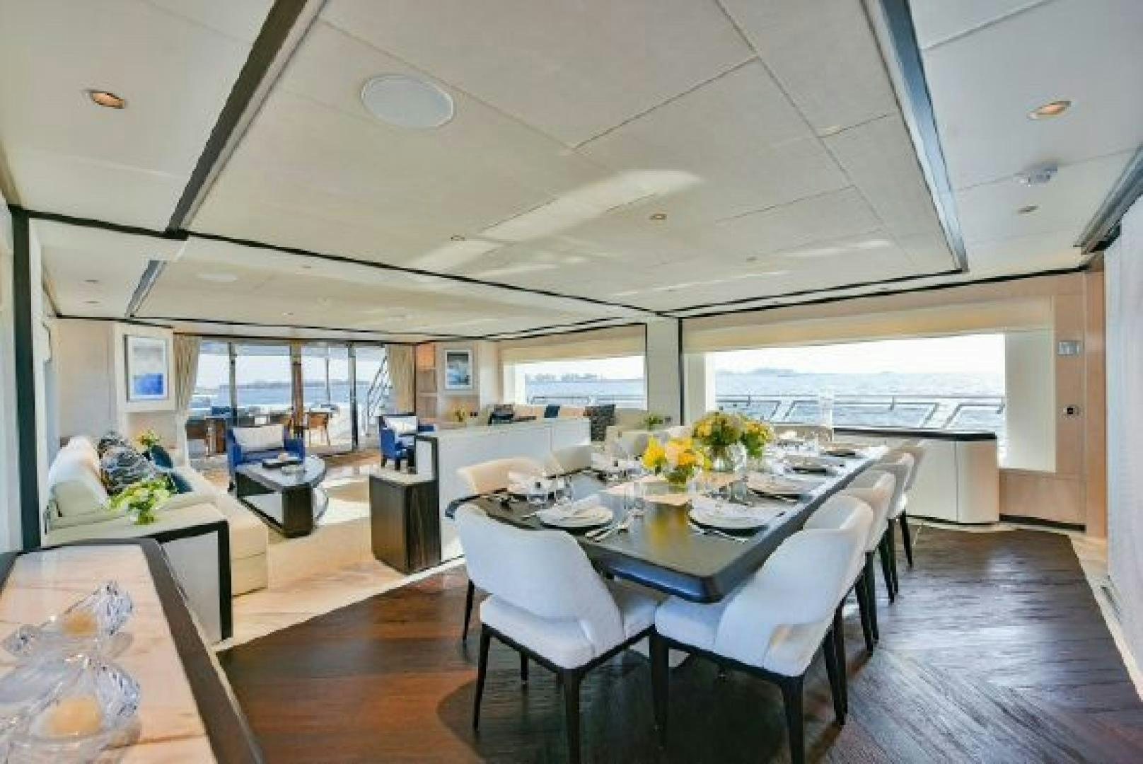 a room with tables and chairs aboard No Name Yacht for Sale