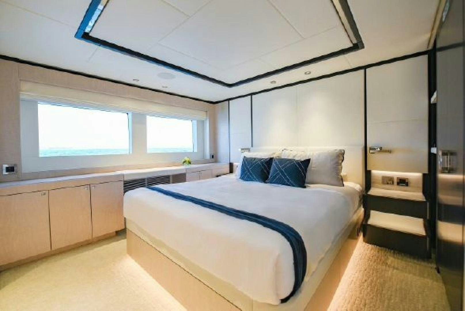 a bedroom with a bed and a window aboard No Name Yacht for Sale