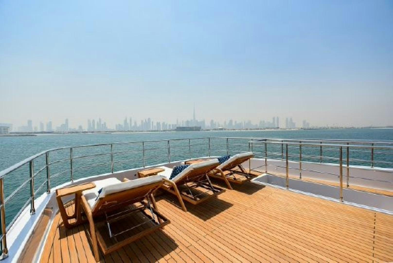 a deck with a view of a city in the distance aboard No Name Yacht for Sale