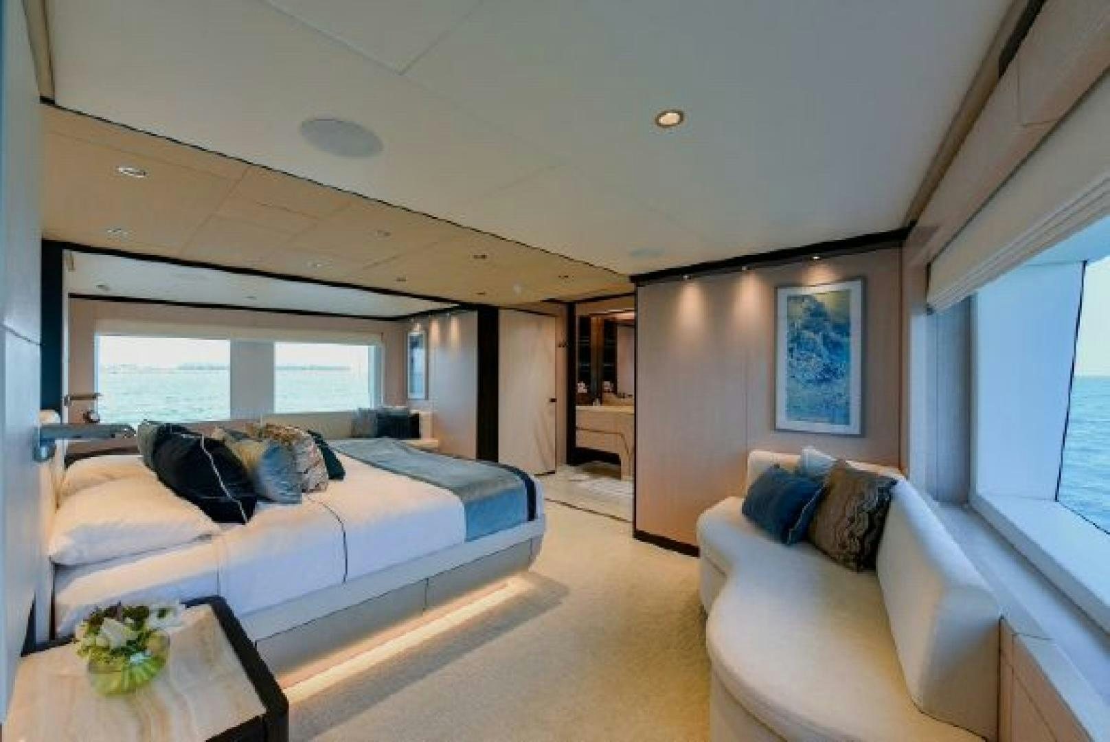 a living room with a couch and a table aboard No Name Yacht for Sale