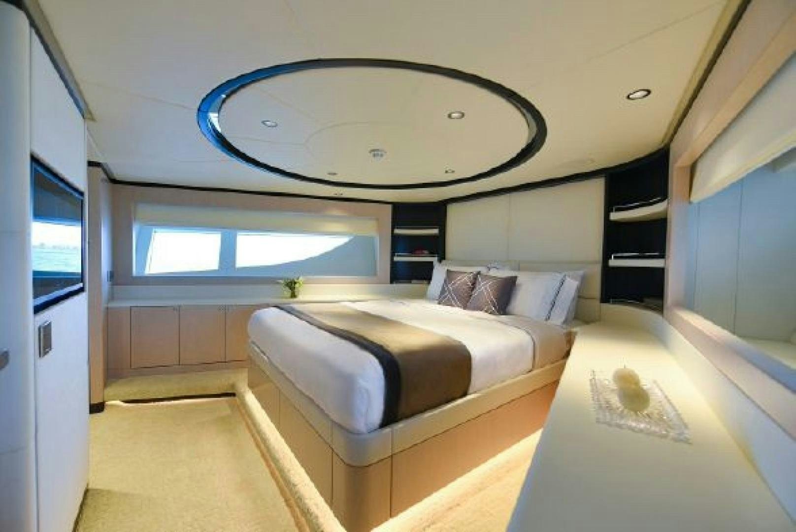 a room with a bed and a large round mirror aboard No Name Yacht for Sale