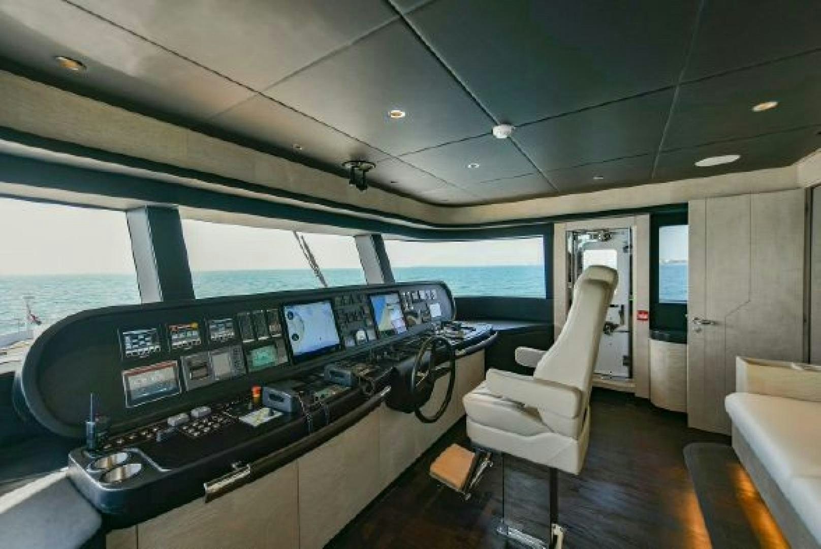 a control room with a table and chairs aboard No Name Yacht for Sale