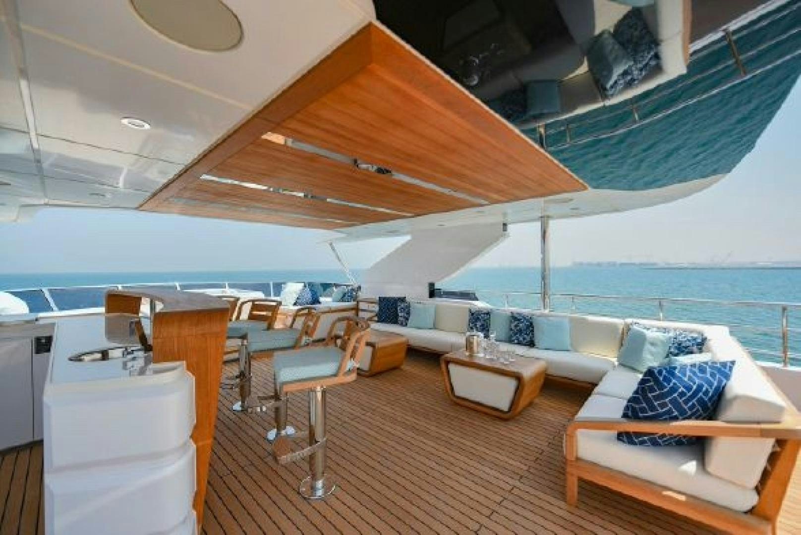 a boat with a deck and chairs aboard No Name Yacht for Sale