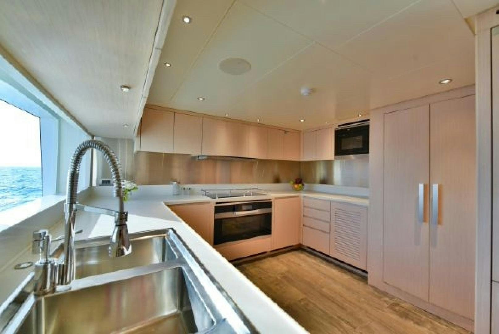 a kitchen with a sink and stove aboard No Name Yacht for Sale