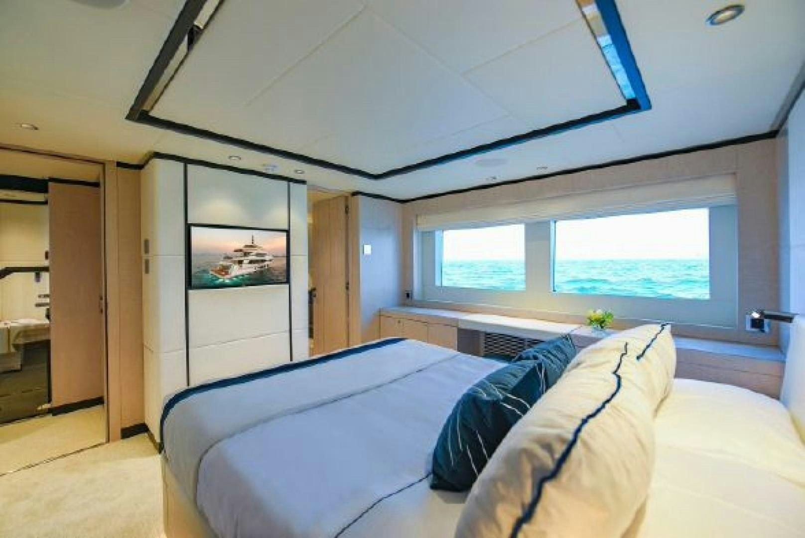 a bedroom with a bed and a window aboard No Name Yacht for Sale