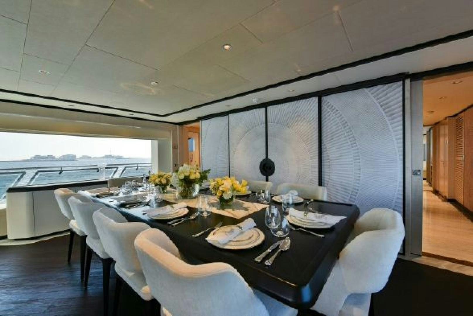 a dining table in a room aboard No Name Yacht for Sale