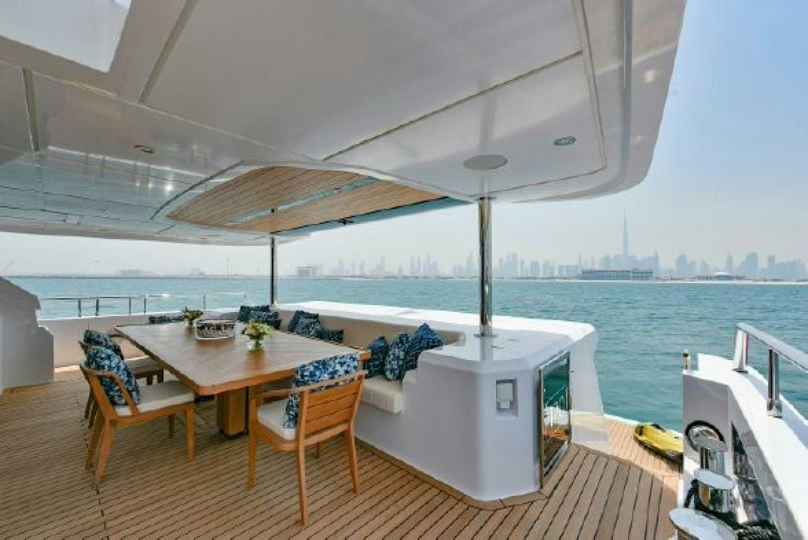 a table and chairs on a deck aboard No Name Yacht for Sale