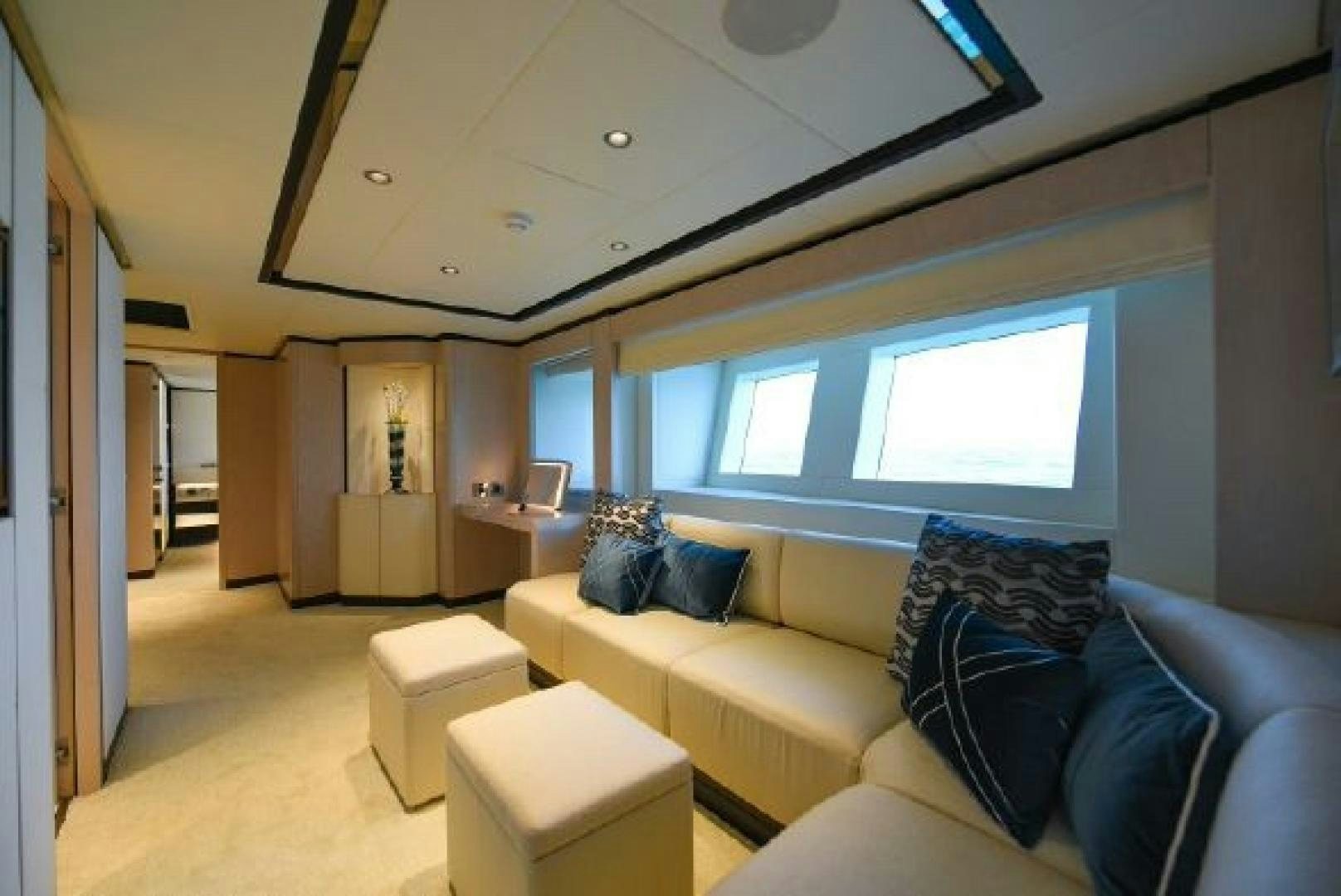 a living room with a couch and a large window aboard No Name Yacht for Sale