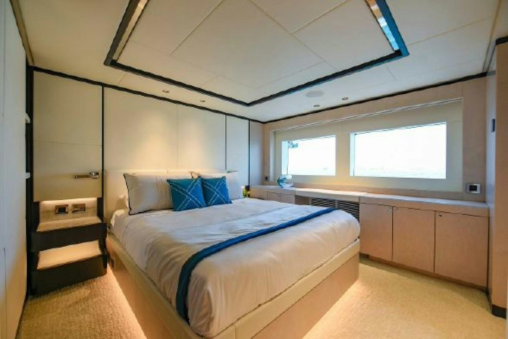 a bedroom with a bed and a desk aboard No Name Yacht for Sale