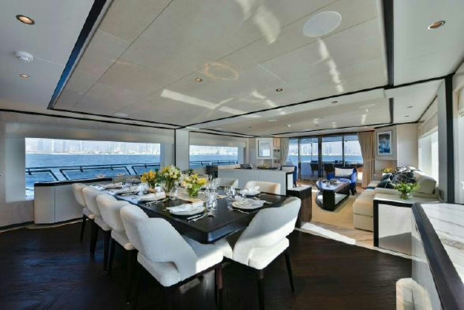a room with tables and chairs aboard No Name Yacht for Sale