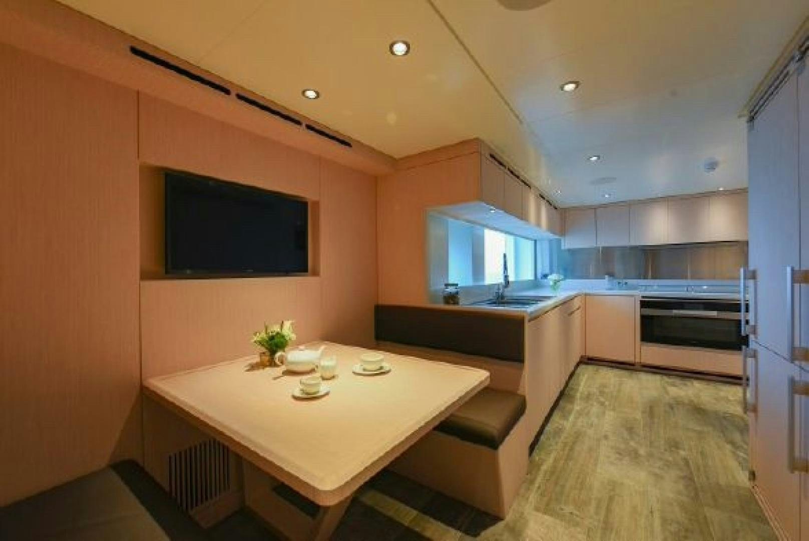 a modern kitchen with a table and chairs aboard No Name Yacht for Sale