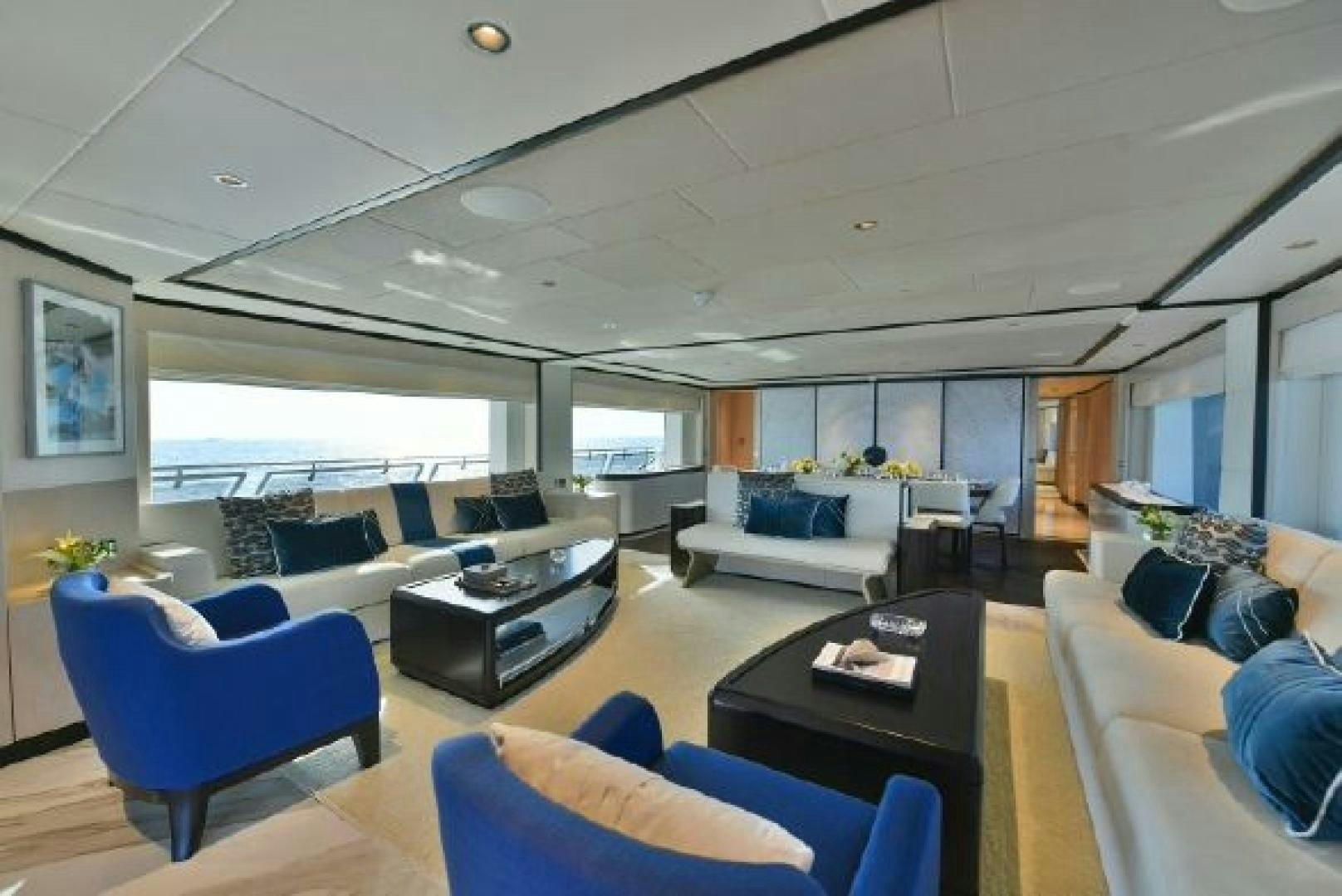 a room with a large window and a large table with chairs and a large window aboard No Name Yacht for Sale
