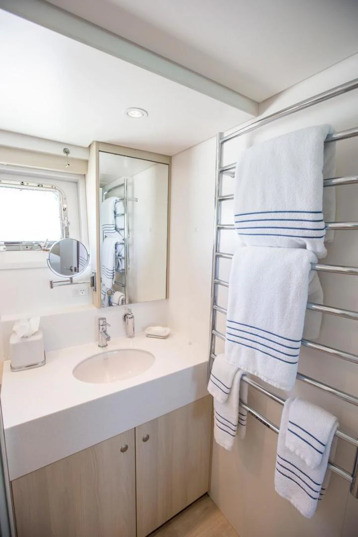 a bathroom with a sink and towels aboard KAHU Yacht for Sale