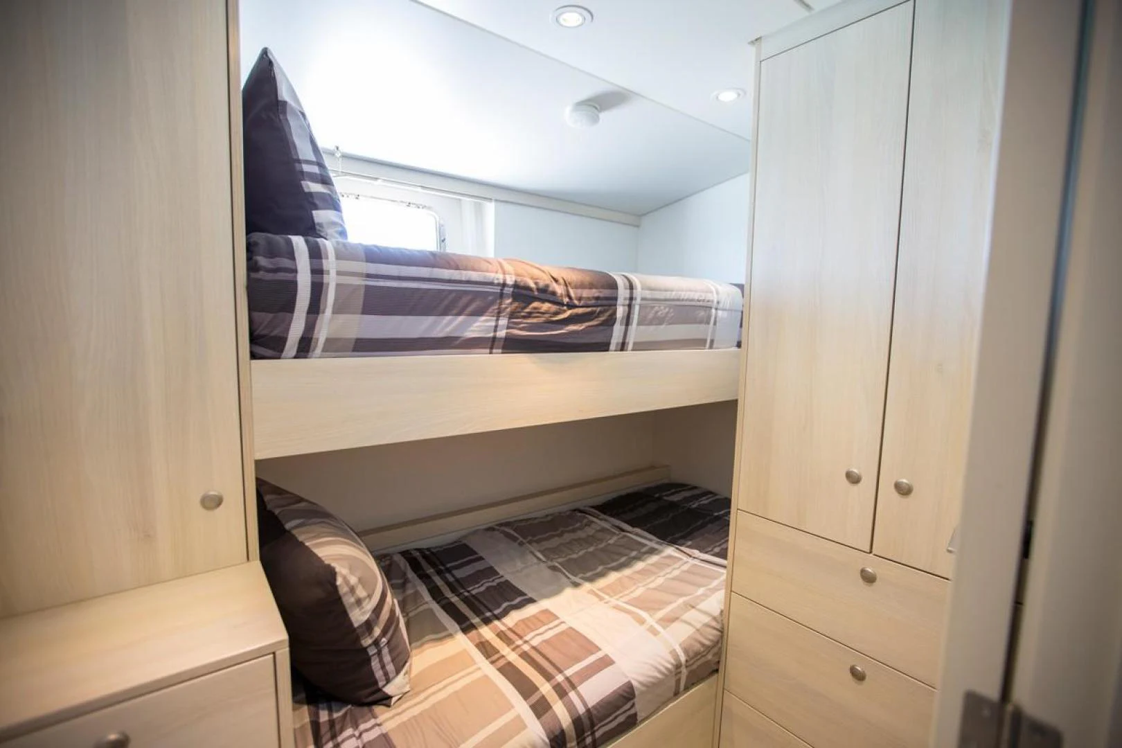 a room with a bed and a closet aboard KAHU Yacht for Sale