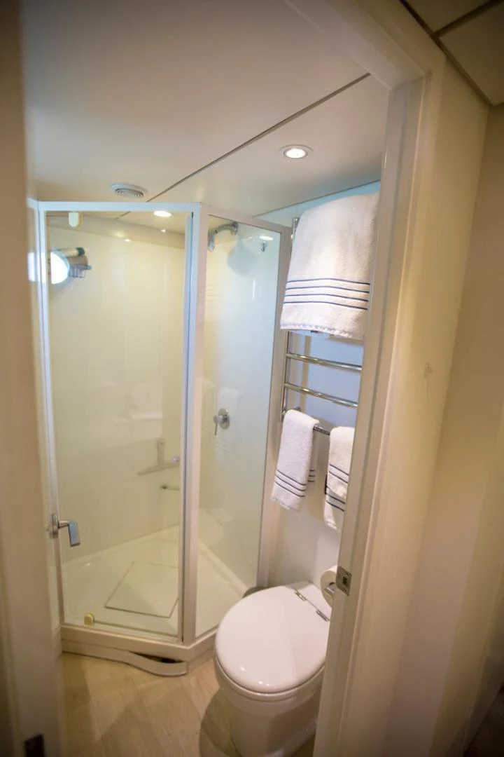 a bathroom with a glass shower aboard KAHU Yacht for Sale