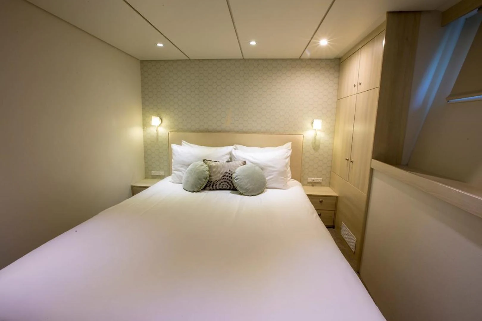 a bed with white sheets aboard KAHU Yacht for Sale