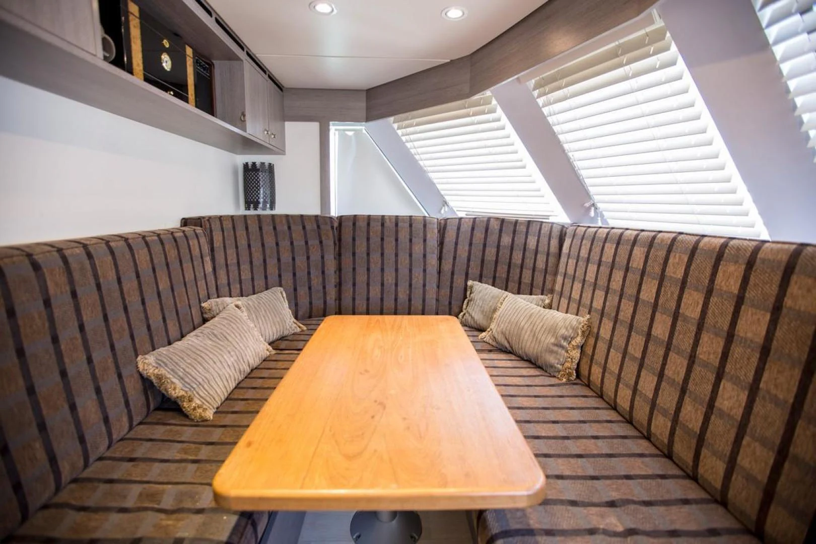 a couch and a table in a room aboard KAHU Yacht for Sale
