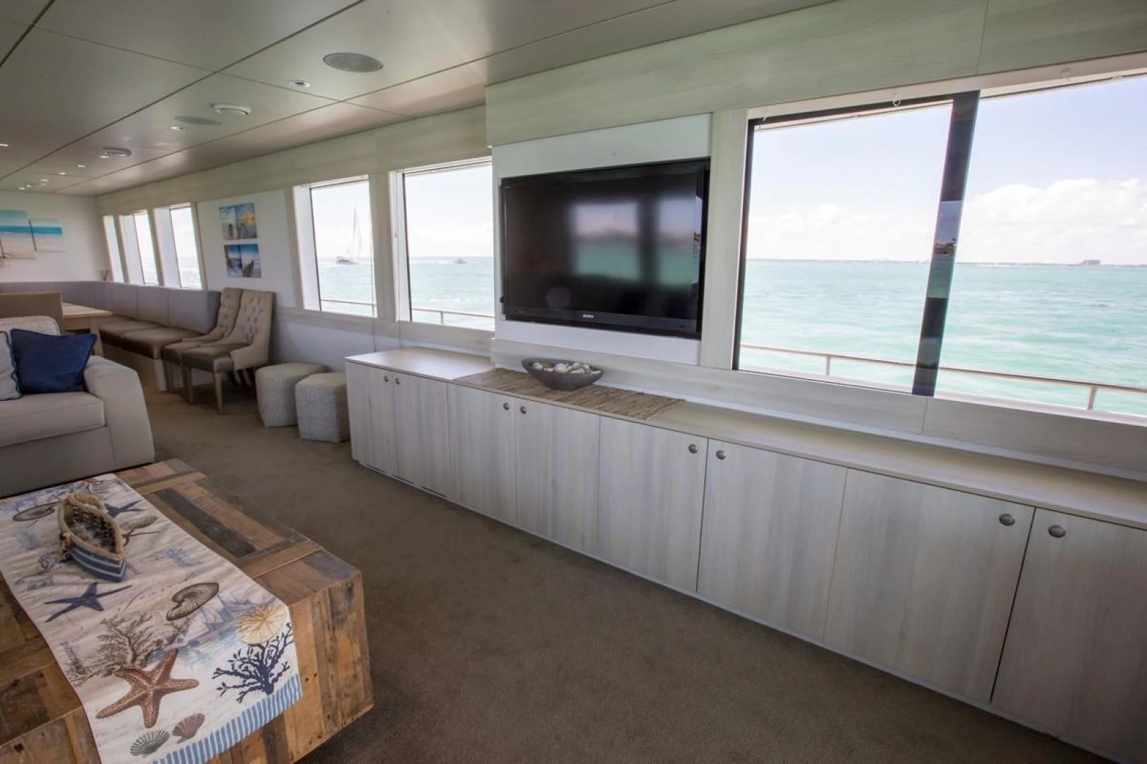 a living room with a large window aboard KAHU Yacht for Sale