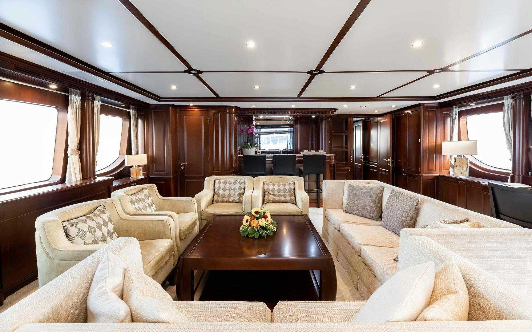 a living room with couches and a table aboard TANUSHA Yacht for Sale