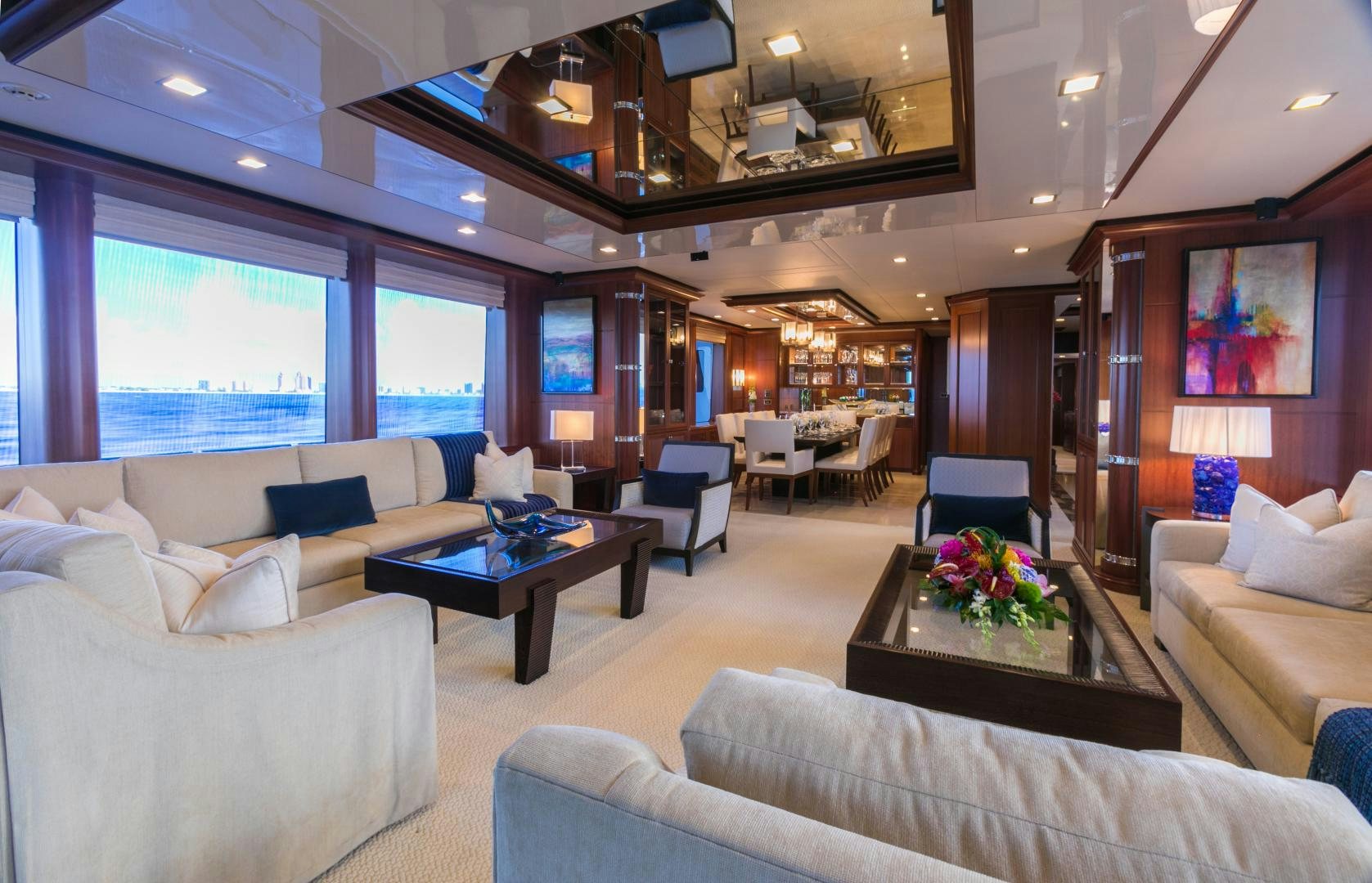 a living room with a large window aboard MY AURORA Yacht for Sale