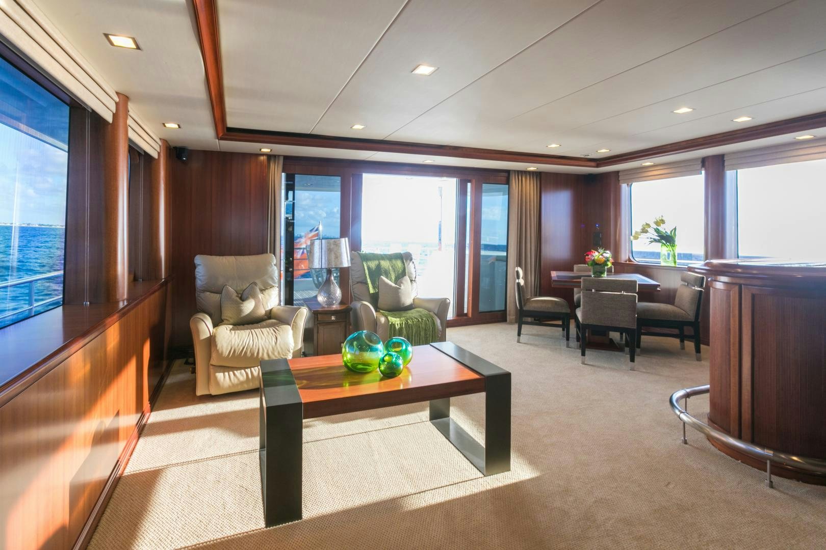 a living room with a table and chairs aboard MY AURORA Yacht for Sale