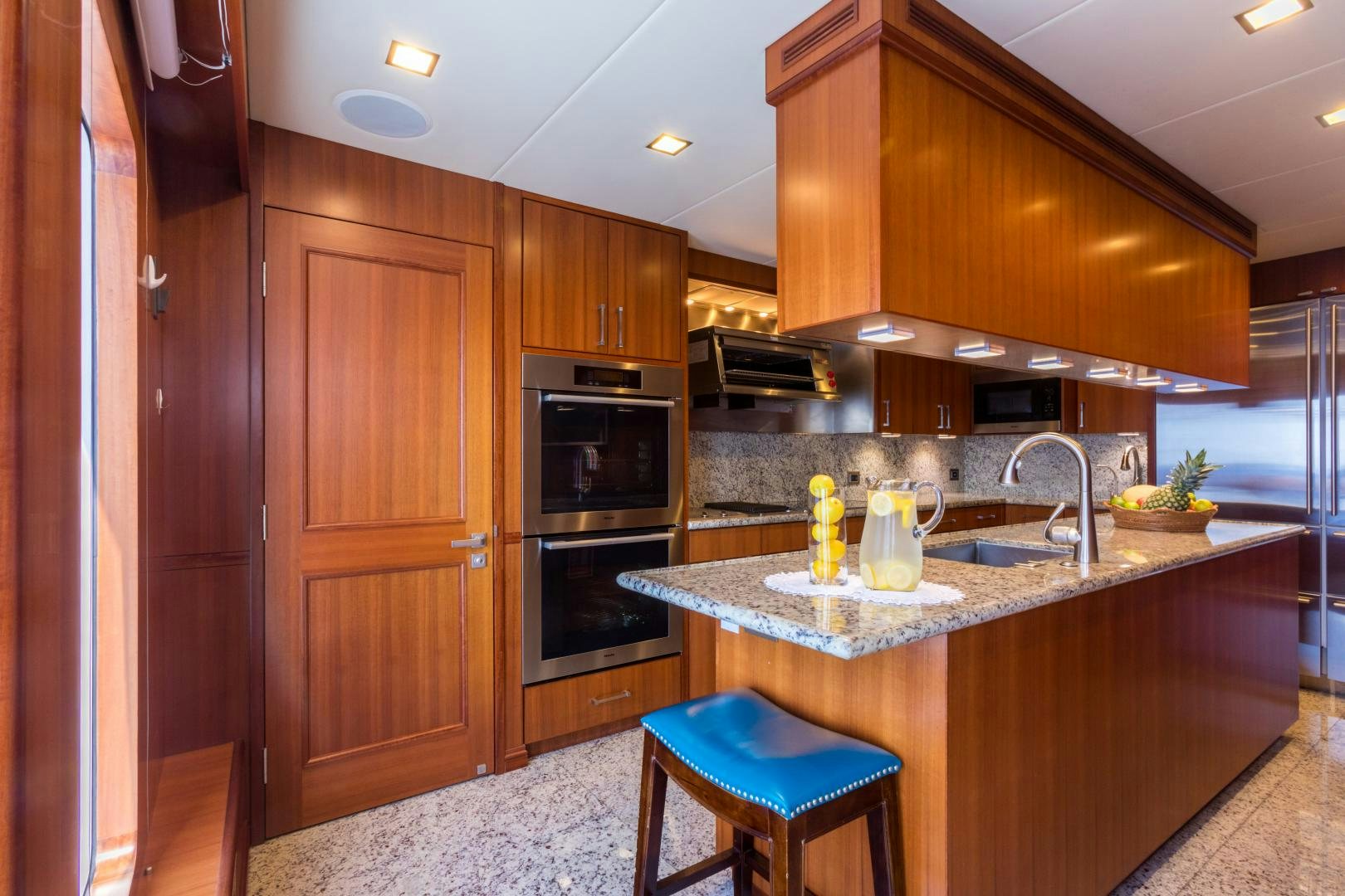 a kitchen with wooden cabinets aboard MY AURORA Yacht for Sale