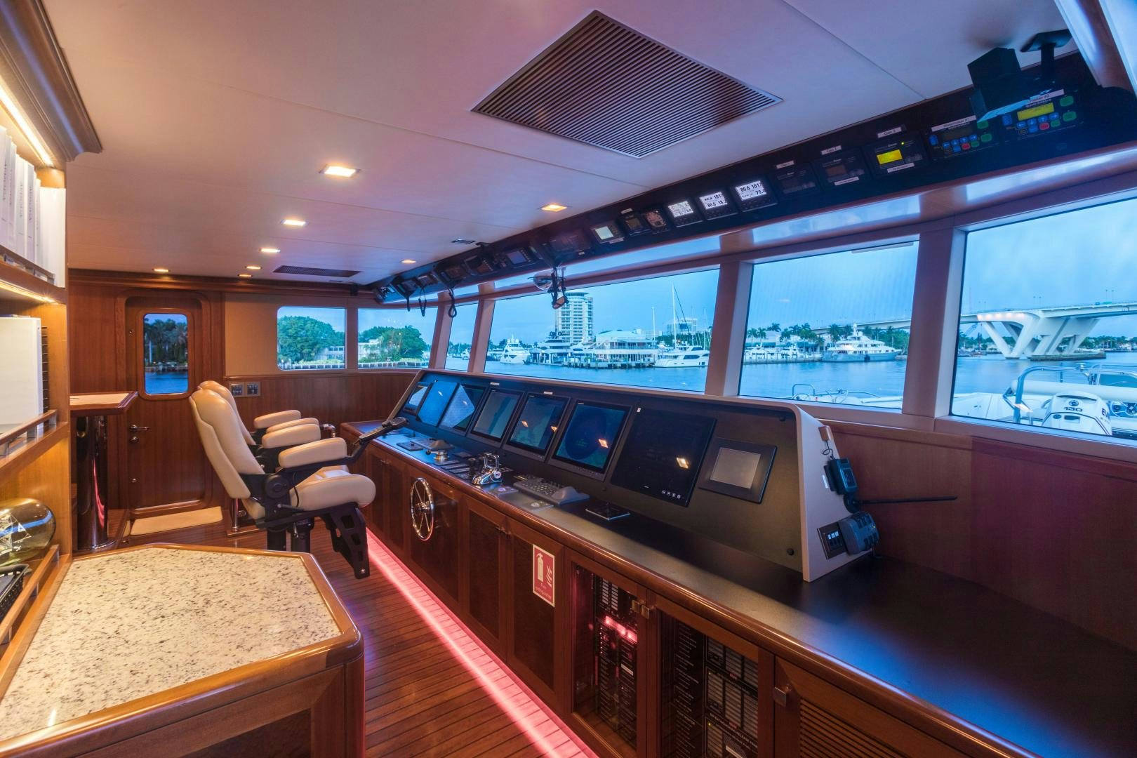 a room with a table and chairs aboard MY AURORA Yacht for Sale