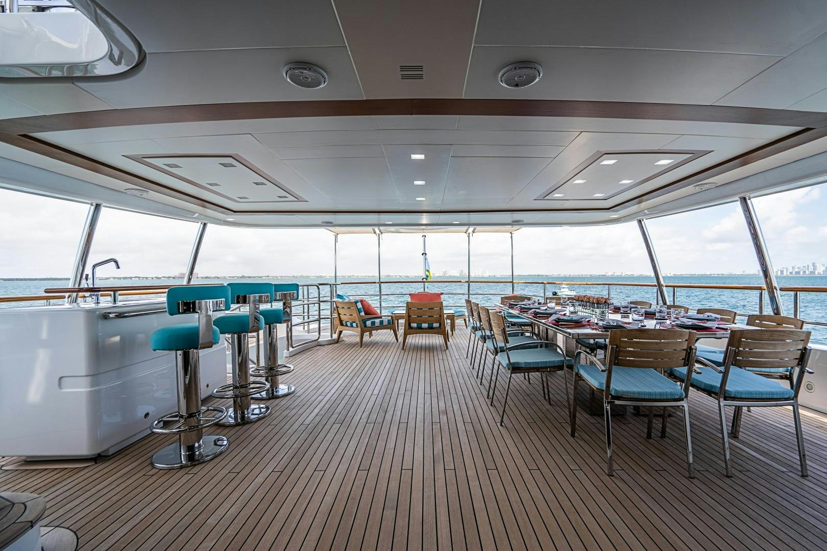 a room with tables and chairs aboard No Name Yacht for Sale