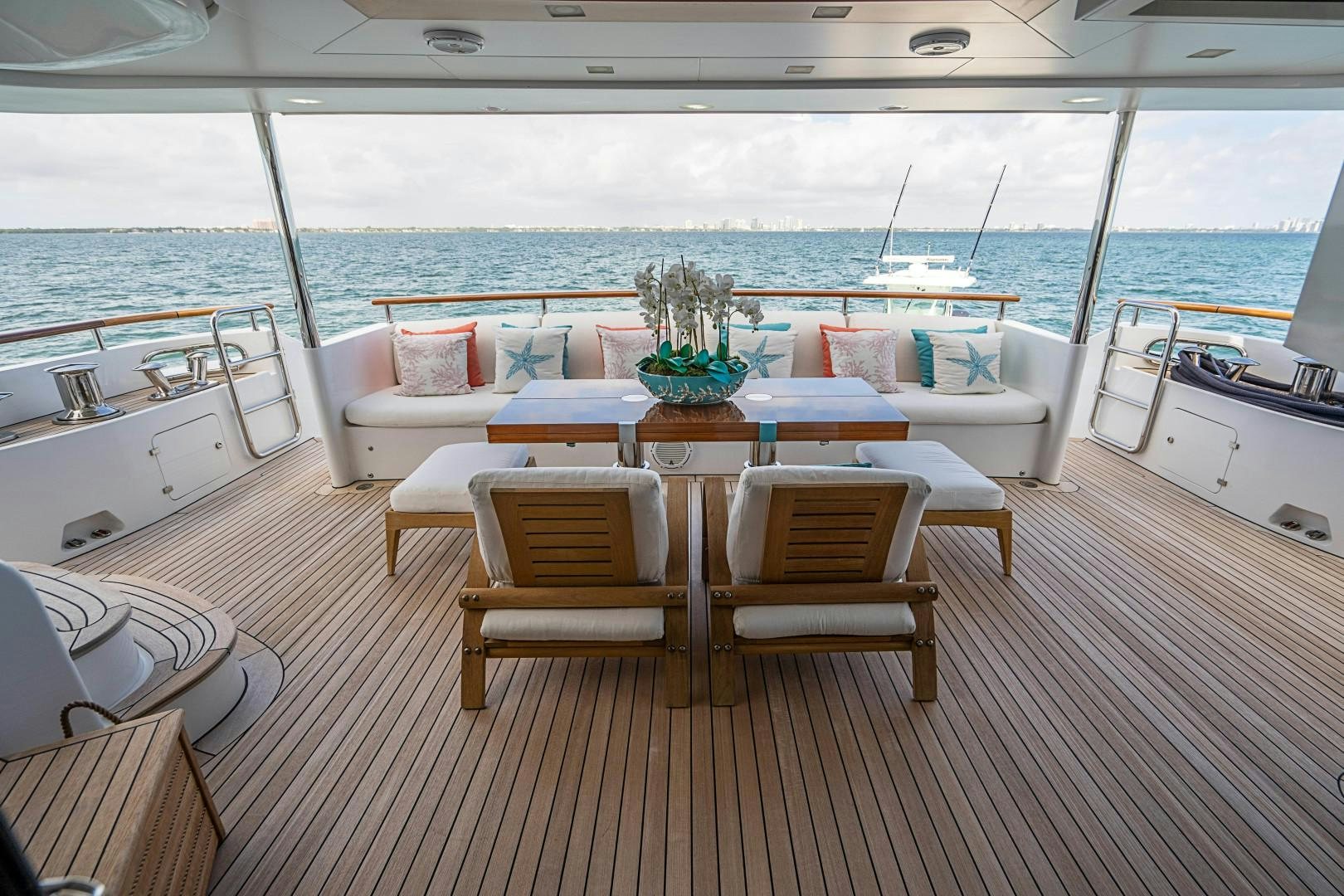 a room with a table chairs and a large body of water aboard No Name Yacht for Sale
